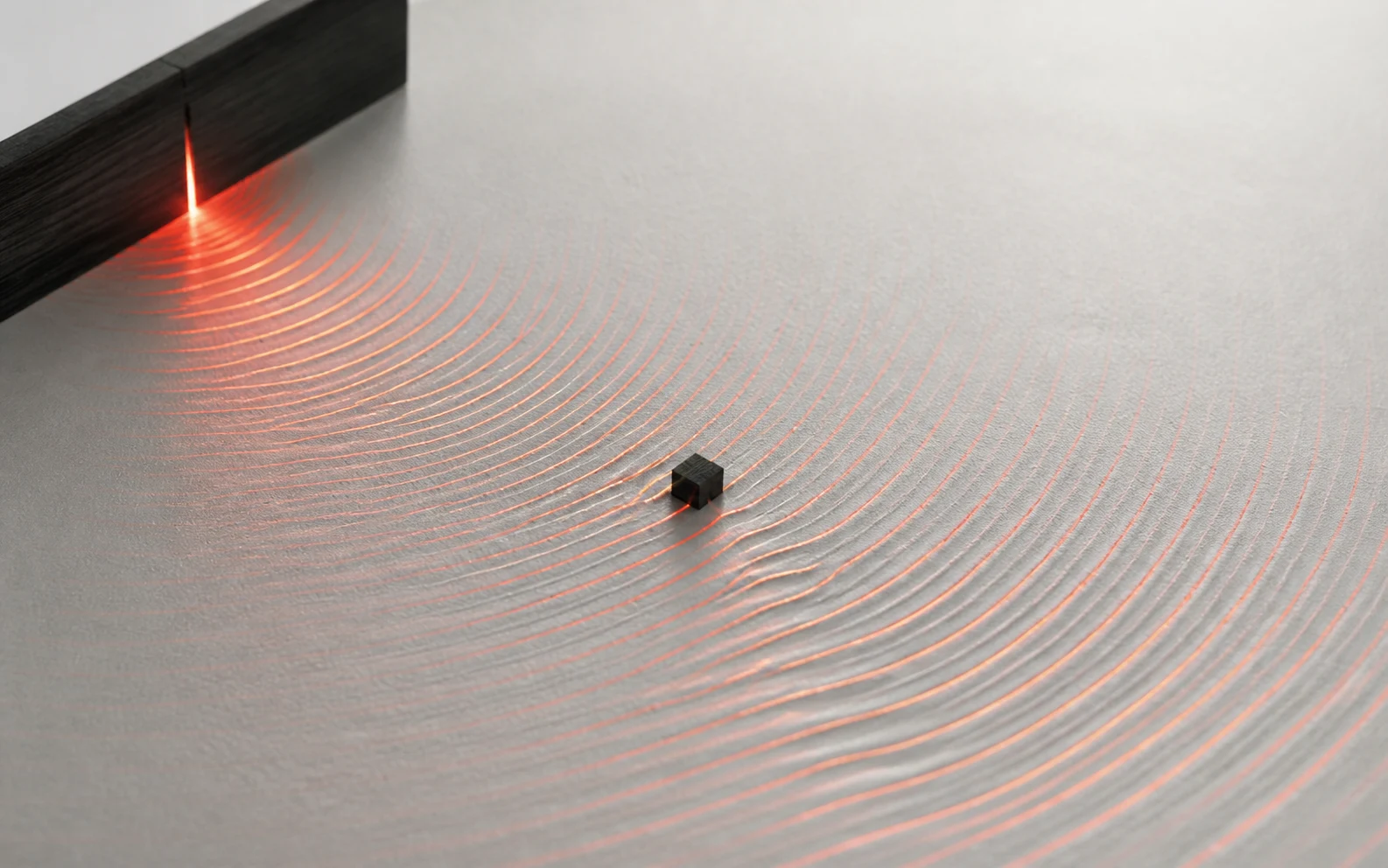 Vermilion diffraction waves expose a hidden disturbance on an aluminium measurement field.